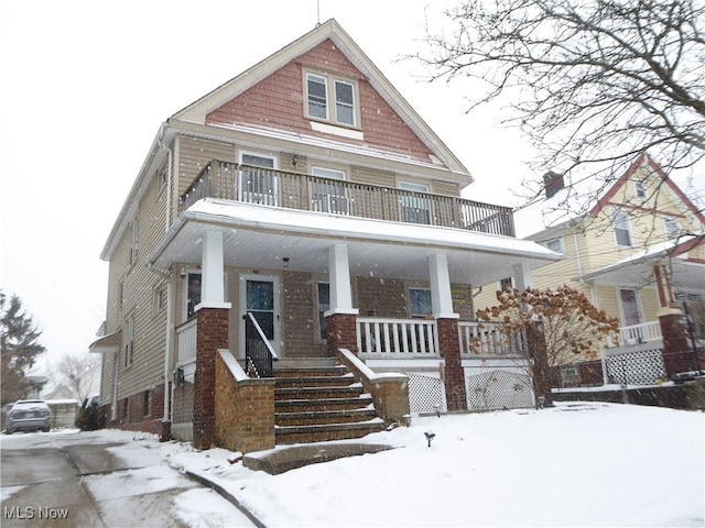 view of front of home with a porch and a balcony