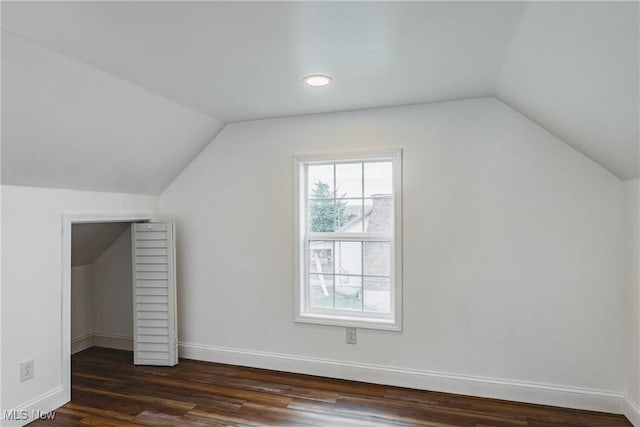 bonus room featuring lofted ceiling and dark hardwood / wood-style floors