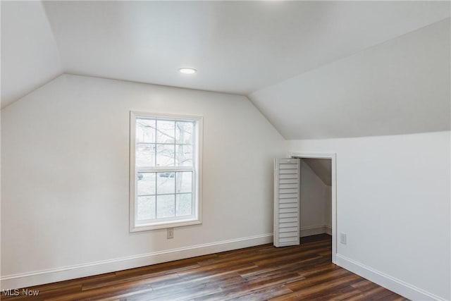 additional living space featuring dark hardwood / wood-style flooring and vaulted ceiling