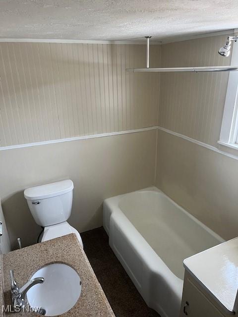 bathroom with vanity, a textured ceiling, and toilet