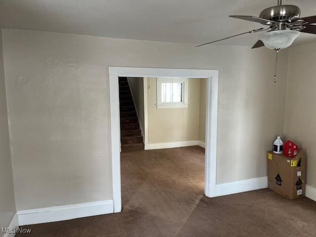 carpeted spare room featuring ceiling fan