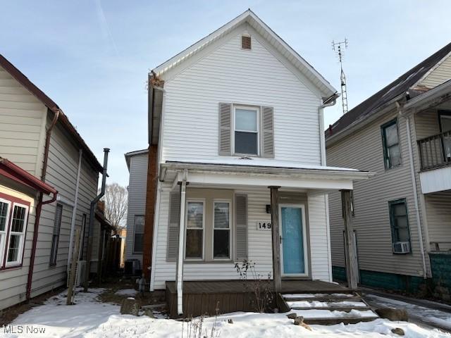 front of property with a porch and cooling unit