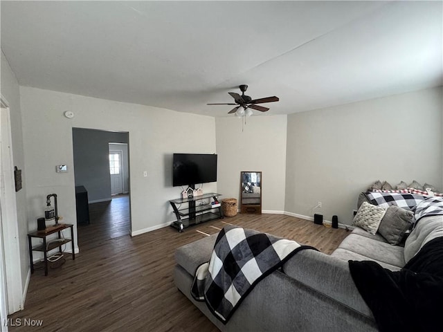 living room with dark hardwood / wood-style flooring and ceiling fan