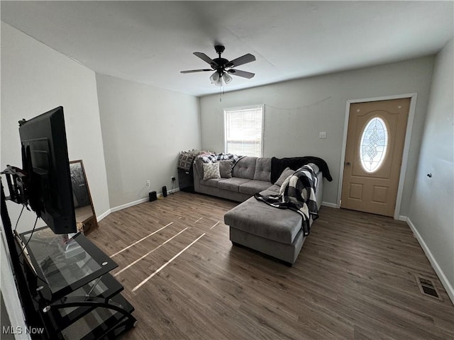 living room with ceiling fan, a healthy amount of sunlight, and dark hardwood / wood-style flooring