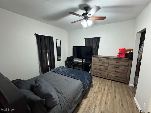 bedroom featuring light hardwood / wood-style flooring and ceiling fan