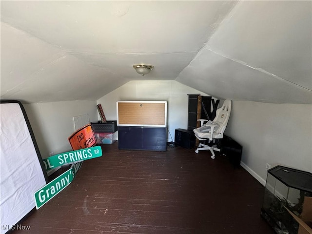 bonus room with lofted ceiling and dark hardwood / wood-style flooring