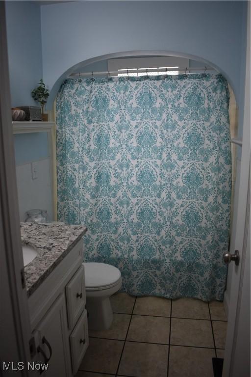 bathroom with vanity, tile patterned floors, and toilet