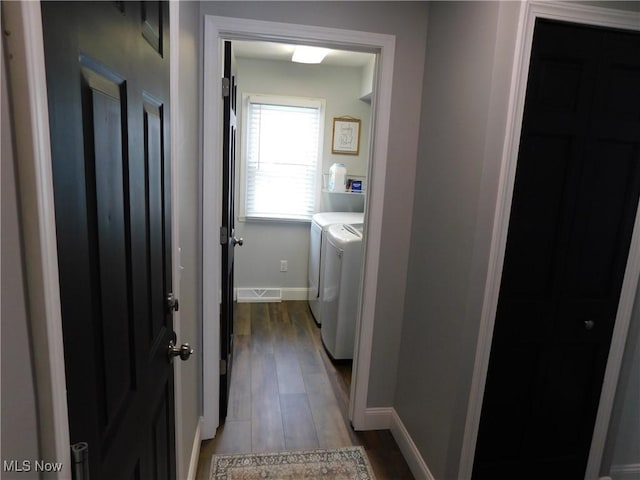 laundry room featuring washer and clothes dryer and light wood-type flooring