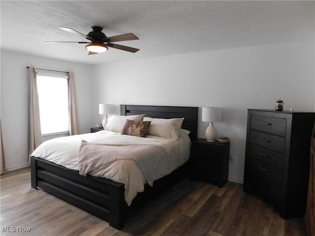 bedroom featuring dark wood-type flooring and ceiling fan