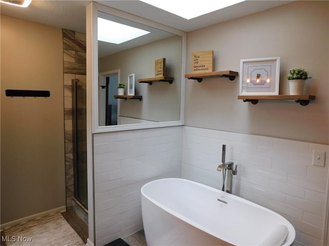 bathroom with plus walk in shower and tile walls