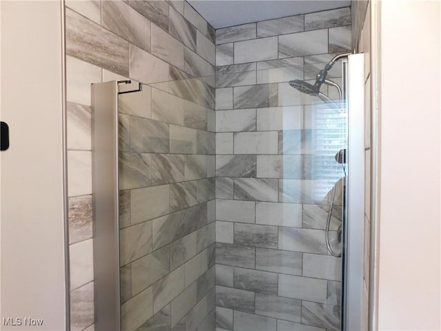 bathroom with a tile shower