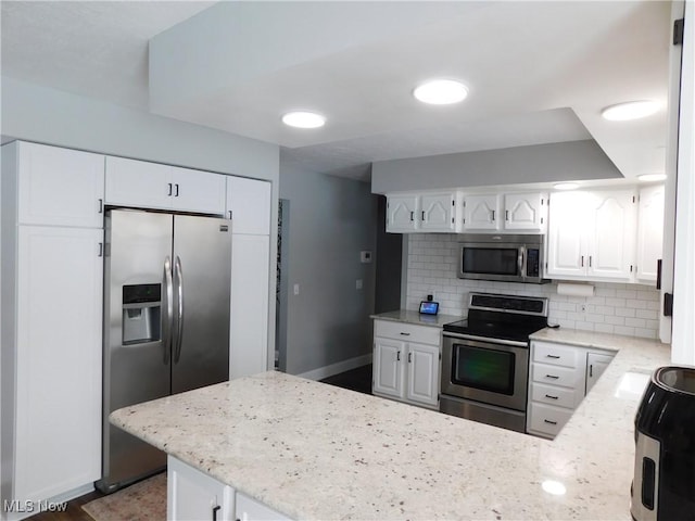 kitchen featuring white cabinetry, appliances with stainless steel finishes, and kitchen peninsula