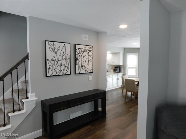 corridor featuring dark hardwood / wood-style flooring