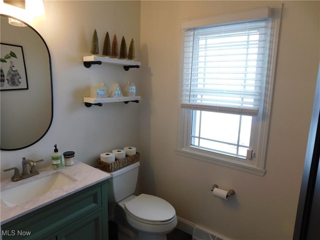 bathroom featuring vanity and toilet