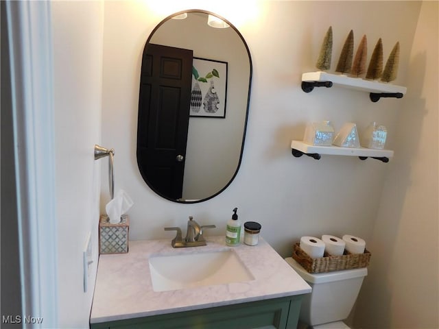 bathroom featuring vanity and toilet