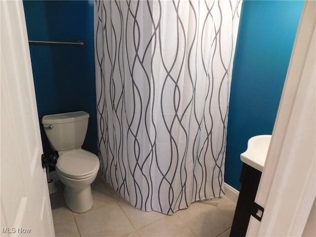 bathroom featuring toilet and tile patterned flooring