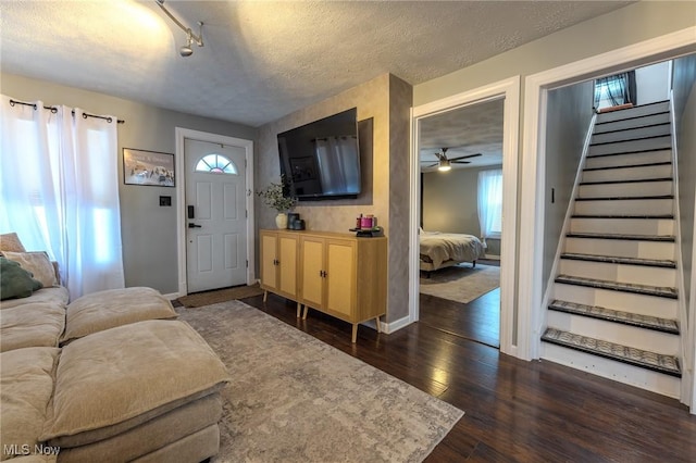 entryway featuring dark hardwood / wood-style floors, a textured ceiling, and rail lighting