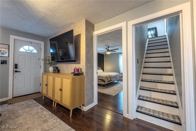 entrance foyer featuring a textured ceiling and dark hardwood / wood-style flooring