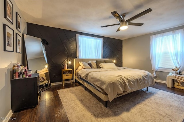 bedroom with ceiling fan and dark hardwood / wood-style floors