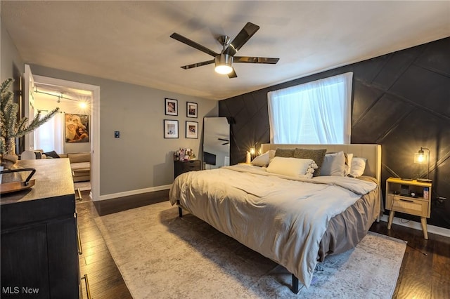 bedroom featuring dark wood-type flooring and ceiling fan