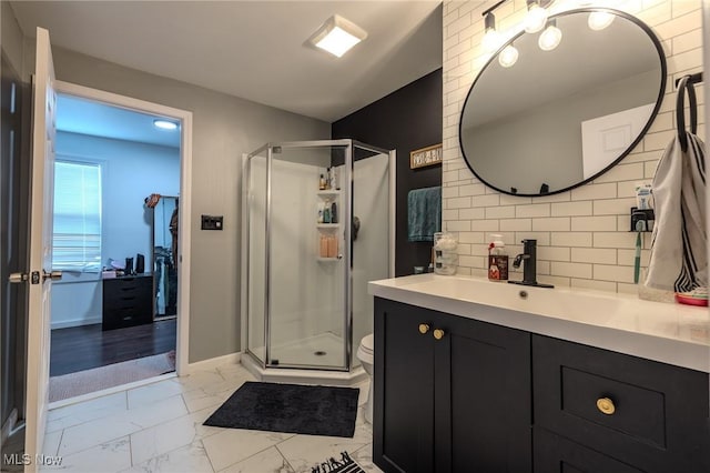 bathroom with a shower with door, vanity, backsplash, and toilet