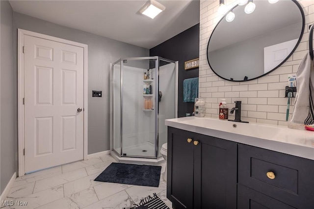 bathroom with vanity, an enclosed shower, backsplash, and toilet