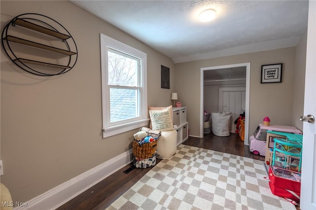 interior space featuring hardwood / wood-style floors, a textured ceiling, and a closet