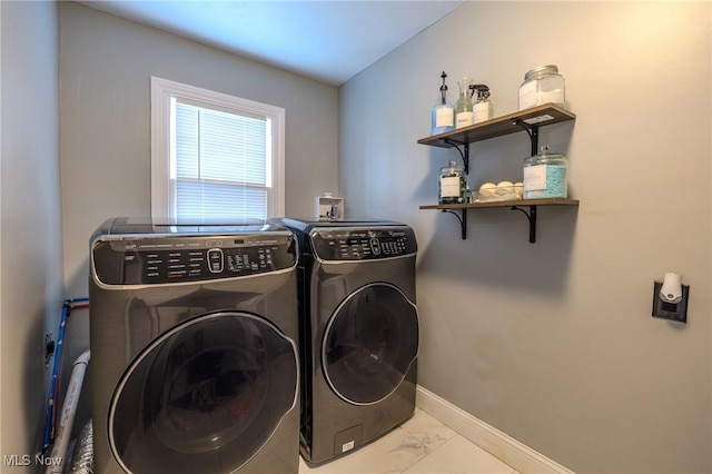 clothes washing area with washing machine and dryer