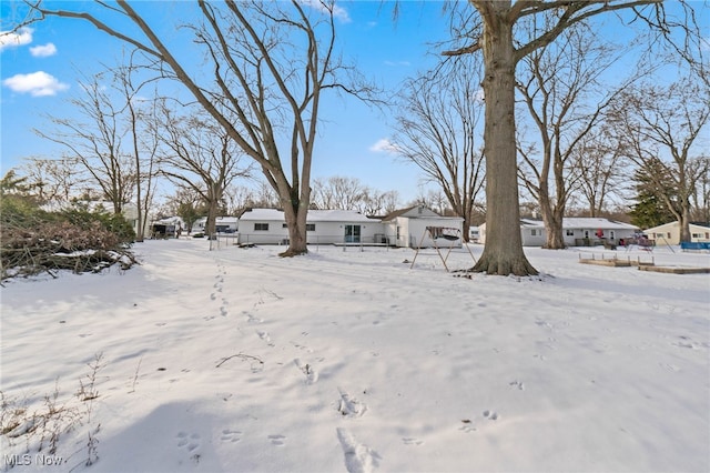 view of yard layered in snow