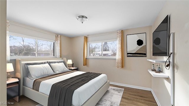 bedroom with hardwood / wood-style flooring