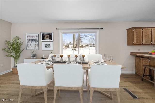 dining area featuring wood-type flooring