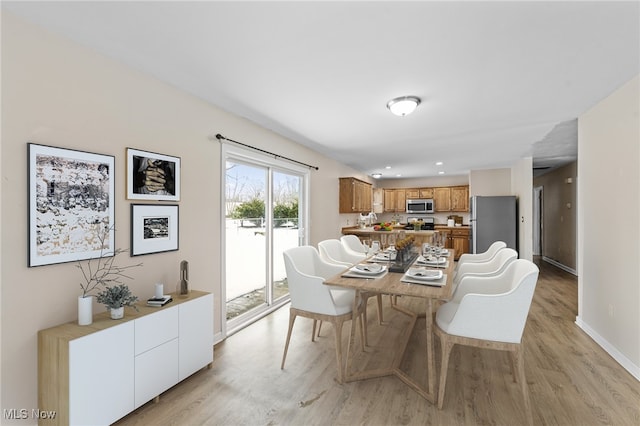 dining area with light hardwood / wood-style floors