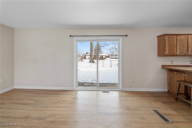 unfurnished dining area featuring light hardwood / wood-style flooring