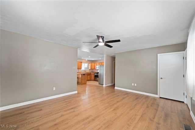 unfurnished living room with light hardwood / wood-style floors and ceiling fan