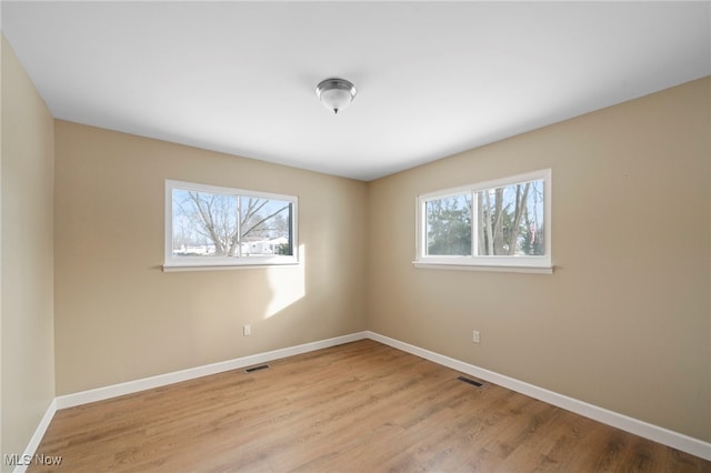 unfurnished room with light hardwood / wood-style floors