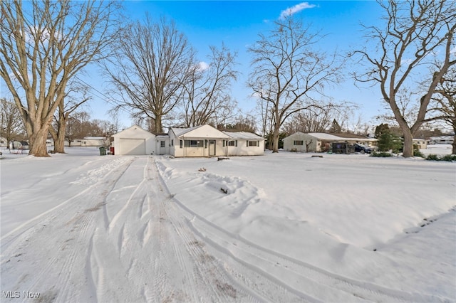 snowy yard with a garage