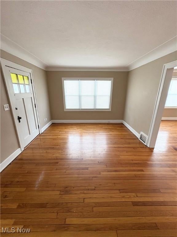 entryway featuring hardwood / wood-style floors and crown molding