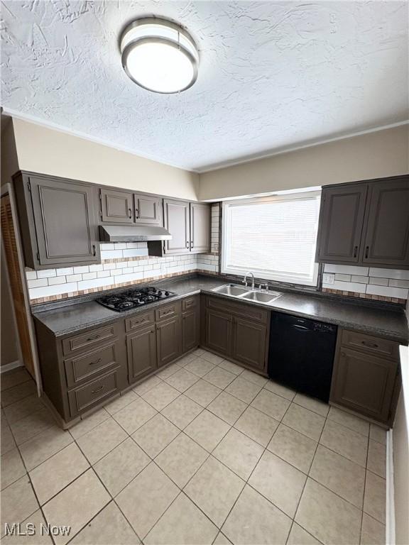 kitchen with tasteful backsplash, sink, black appliances, and light tile patterned flooring