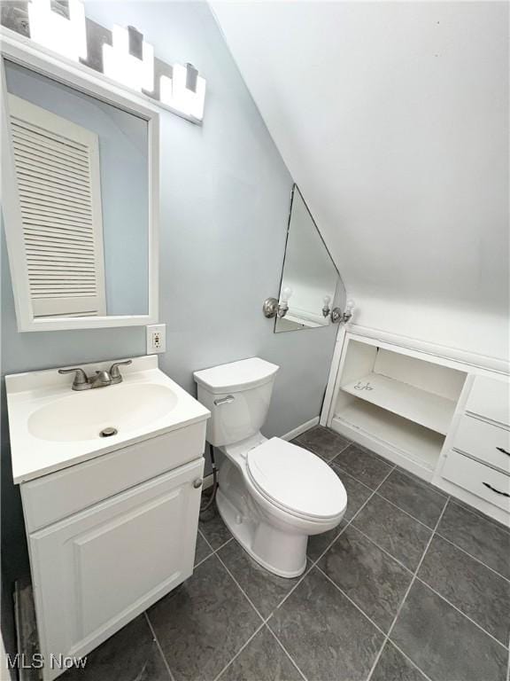 bathroom featuring tile patterned floors, vanity, and toilet