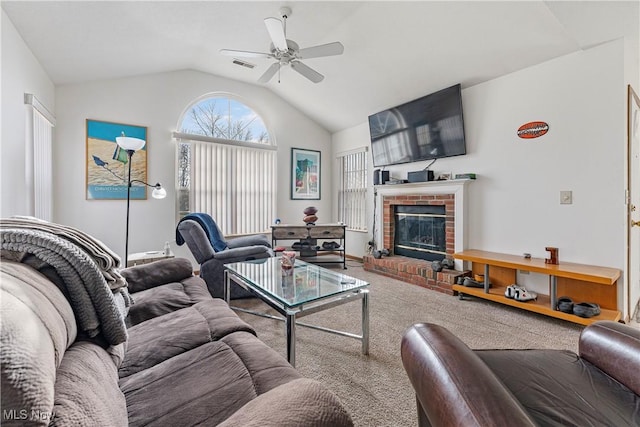 carpeted living room with ceiling fan, lofted ceiling, and a fireplace