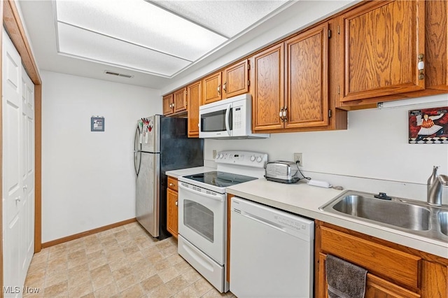 kitchen featuring sink and white appliances