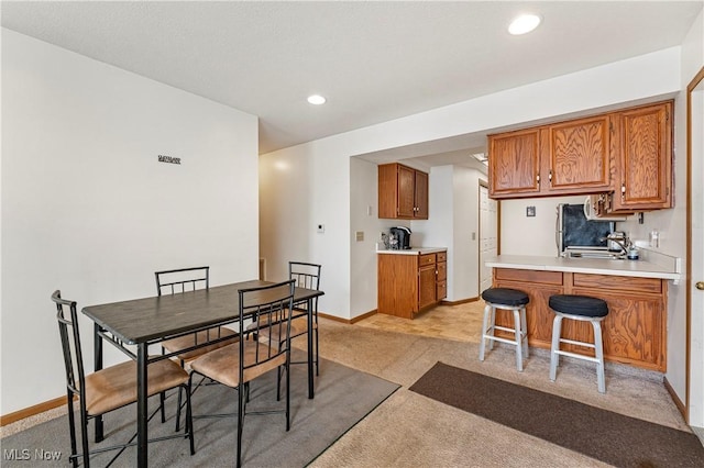 carpeted dining space with sink