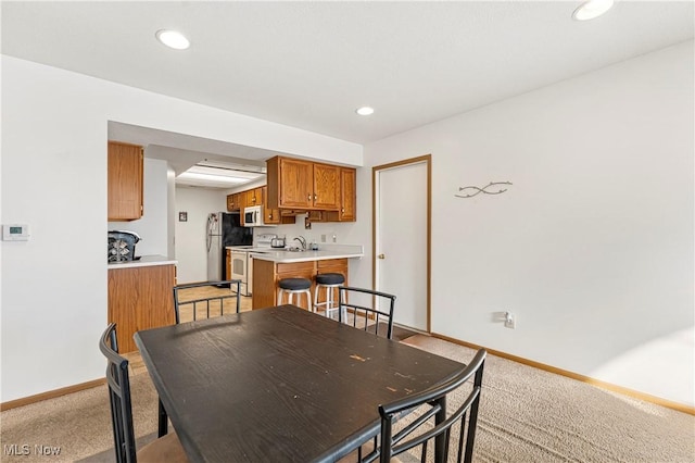 dining room featuring light colored carpet