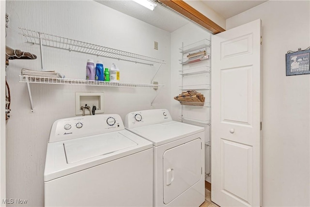 clothes washing area featuring washer and dryer