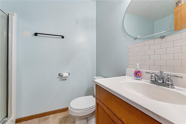 bathroom with tile patterned floors, vanity, toilet, and backsplash