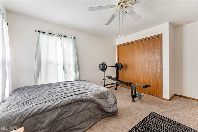 bedroom with light carpet, ceiling fan, and a closet