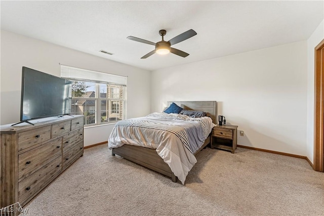 bedroom with ceiling fan and light carpet