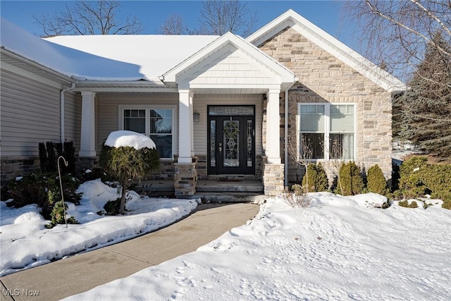 view of snow covered property entrance