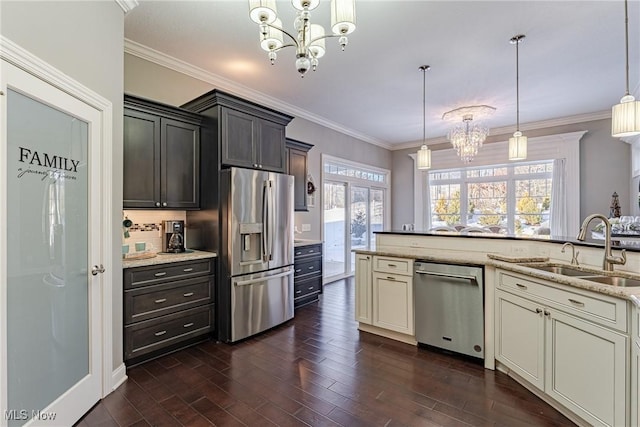 kitchen with an inviting chandelier, decorative light fixtures, dark hardwood / wood-style floors, stainless steel appliances, and cream cabinets