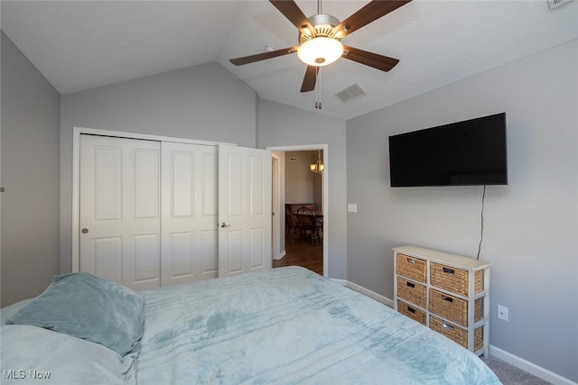 bedroom with vaulted ceiling, a closet, and ceiling fan